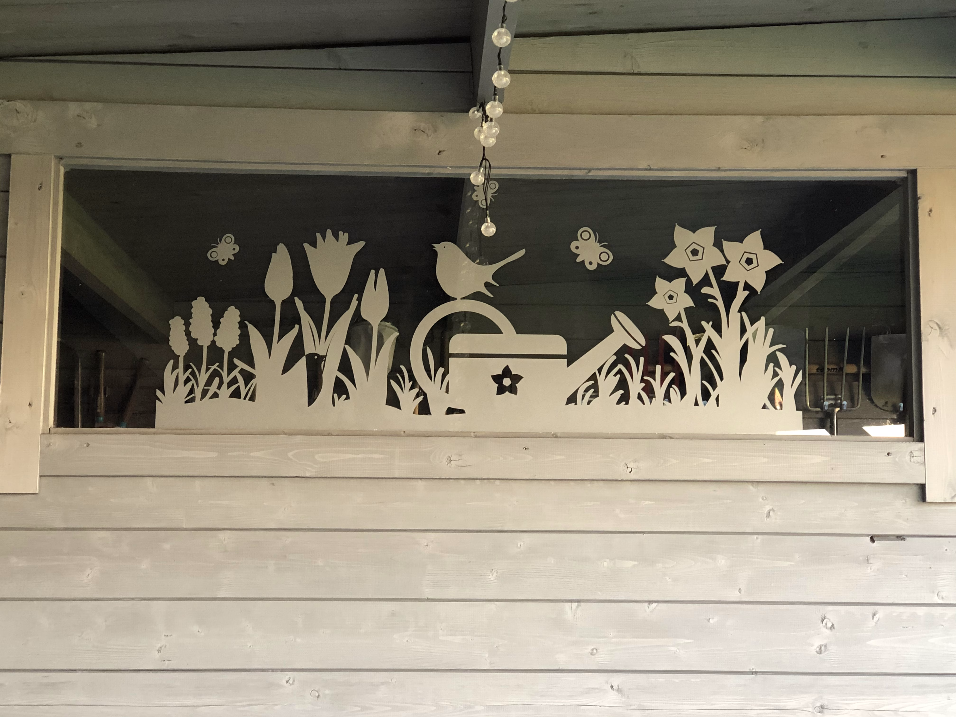 Glasdekor für Fenster im Design Blumenwiese auf einem schmalen Fenster
